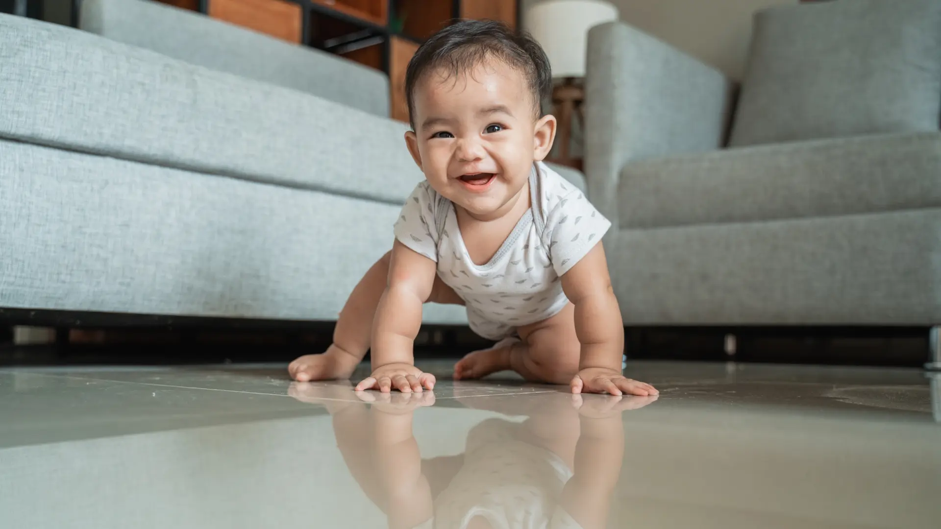 A healthy Indian baby at 6 months old sits up unsupported, a key baby milestone in child development.